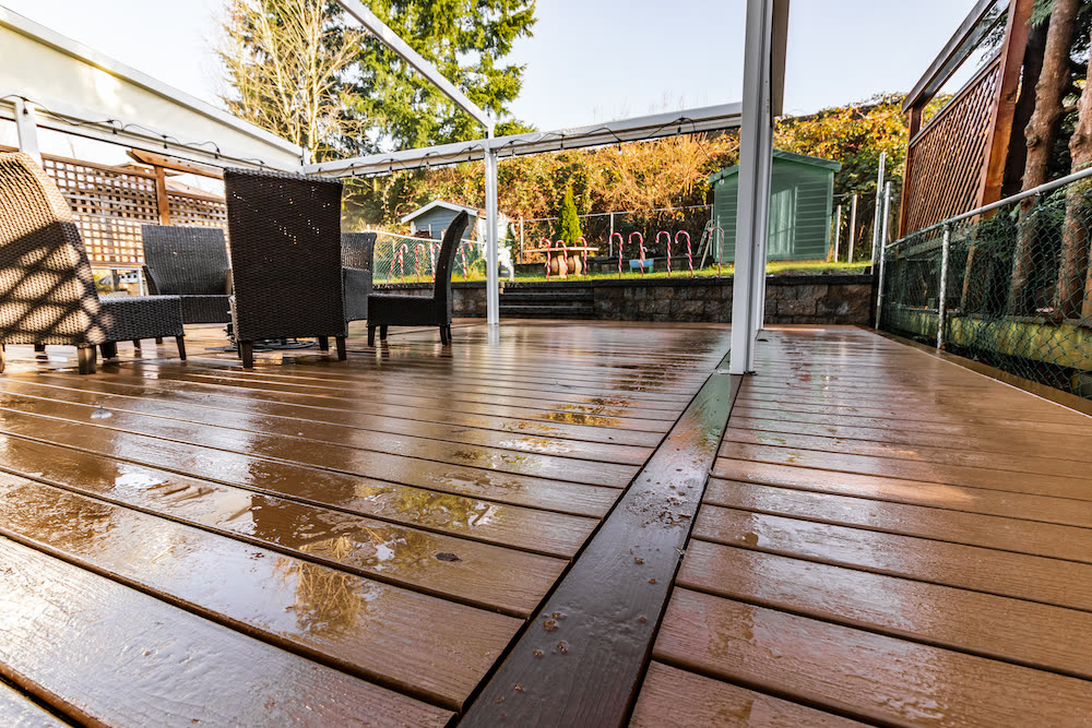 Composite deck with patio cover on a rainy day showing weather resistance