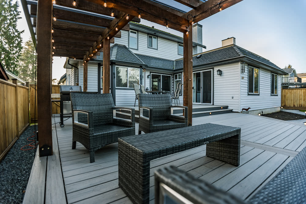 Timber pergola with string lights over composite deck
