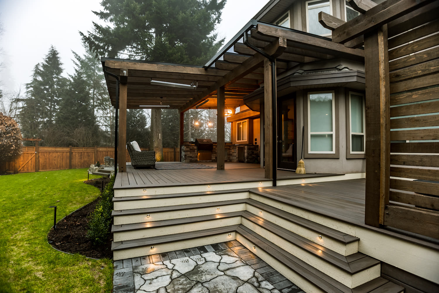 Custom covered deck with LED stair lighting and timber frame