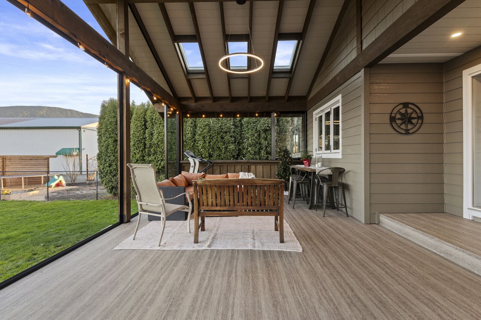Integrated sunroom with solid roof matching the home's shingles, blending seamlessly with the existing structure